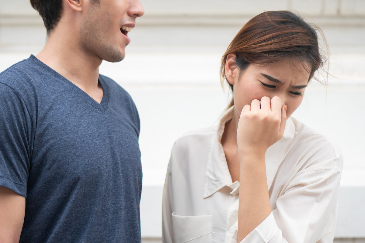 woman suffering from man bad breath, concept of tooth decay, gingivitis, poor oral hygiene, bad breath or ordor smell from unhealthy mouth, poor personality, oral hygiene health care